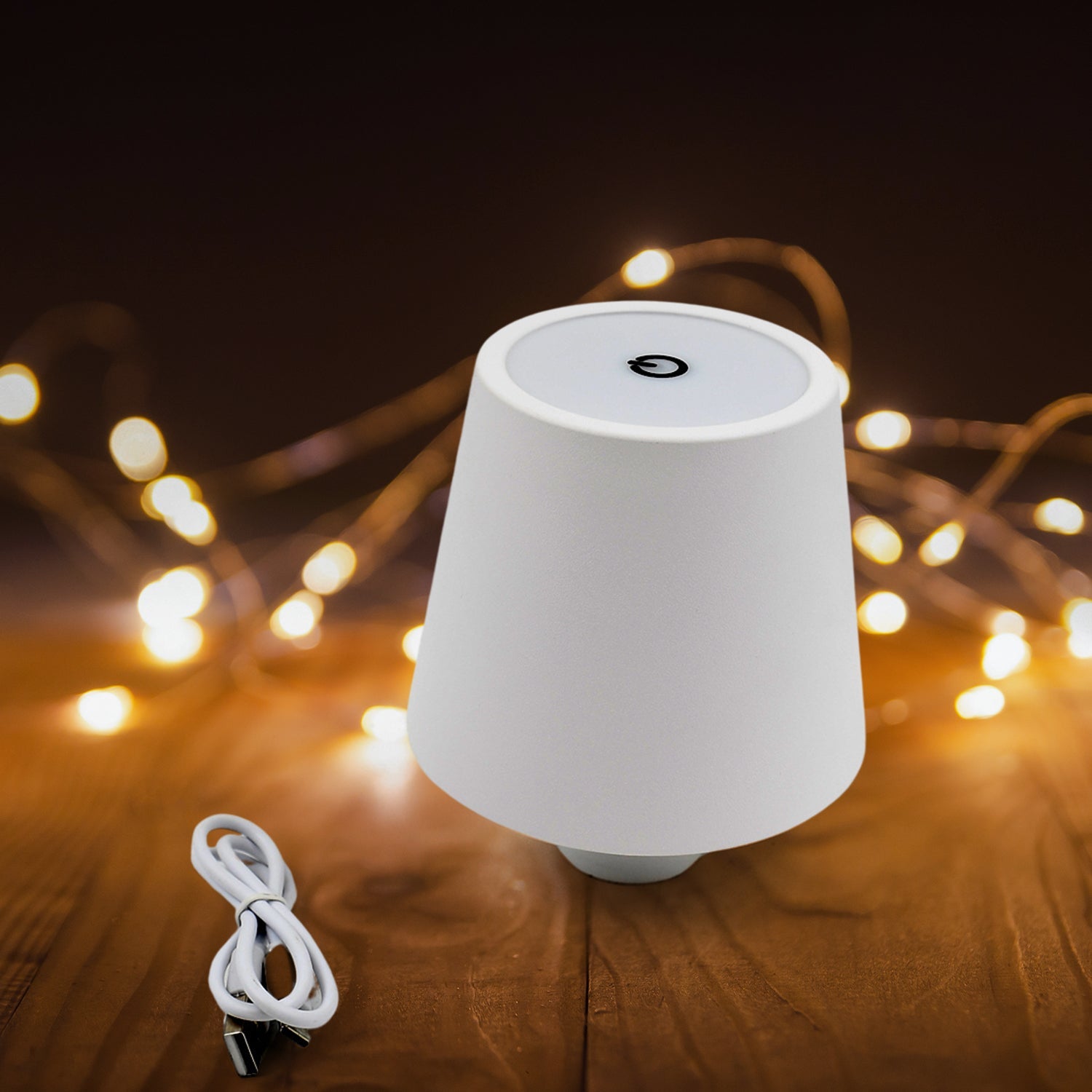 Close-up view of the touch control button on the portable LED bottle lamp.