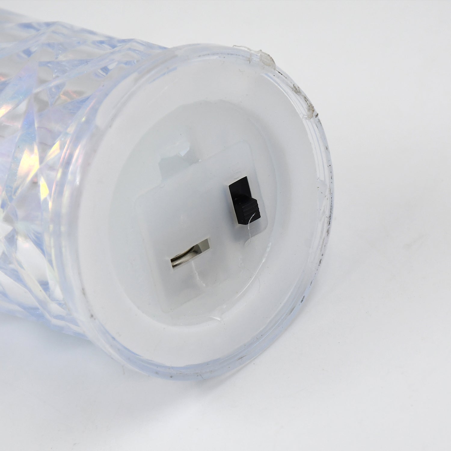 Hand holding one of the flameless LED candles, highlighting its safe, battery-operated design.