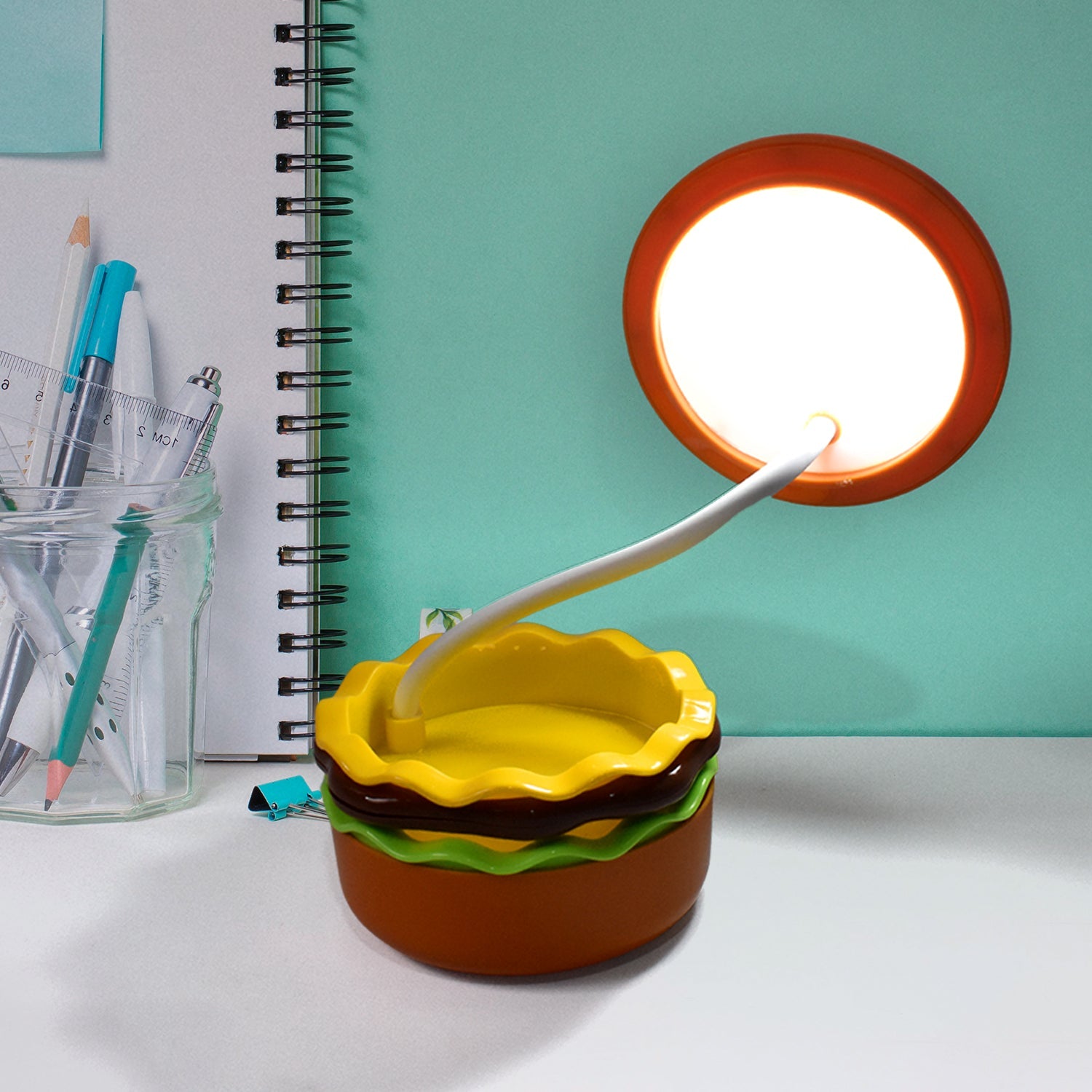 Adjustable burger LED lamp with its gooseneck extended for focused light.