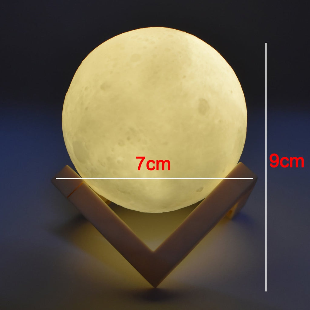 The 3D moon lamp illuminated, highlighting its spherical shape and touch-sensitive controls.