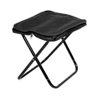 Folding Camping Stool fully assembled next to camping gear, ready for relaxation.