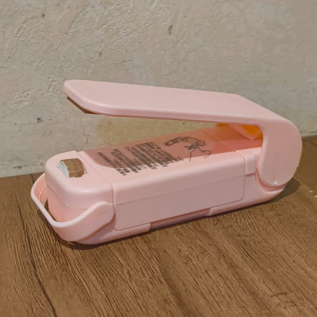 Hand holding the Mini Plastic Bag Sealer, highlighting its ergonomic design.