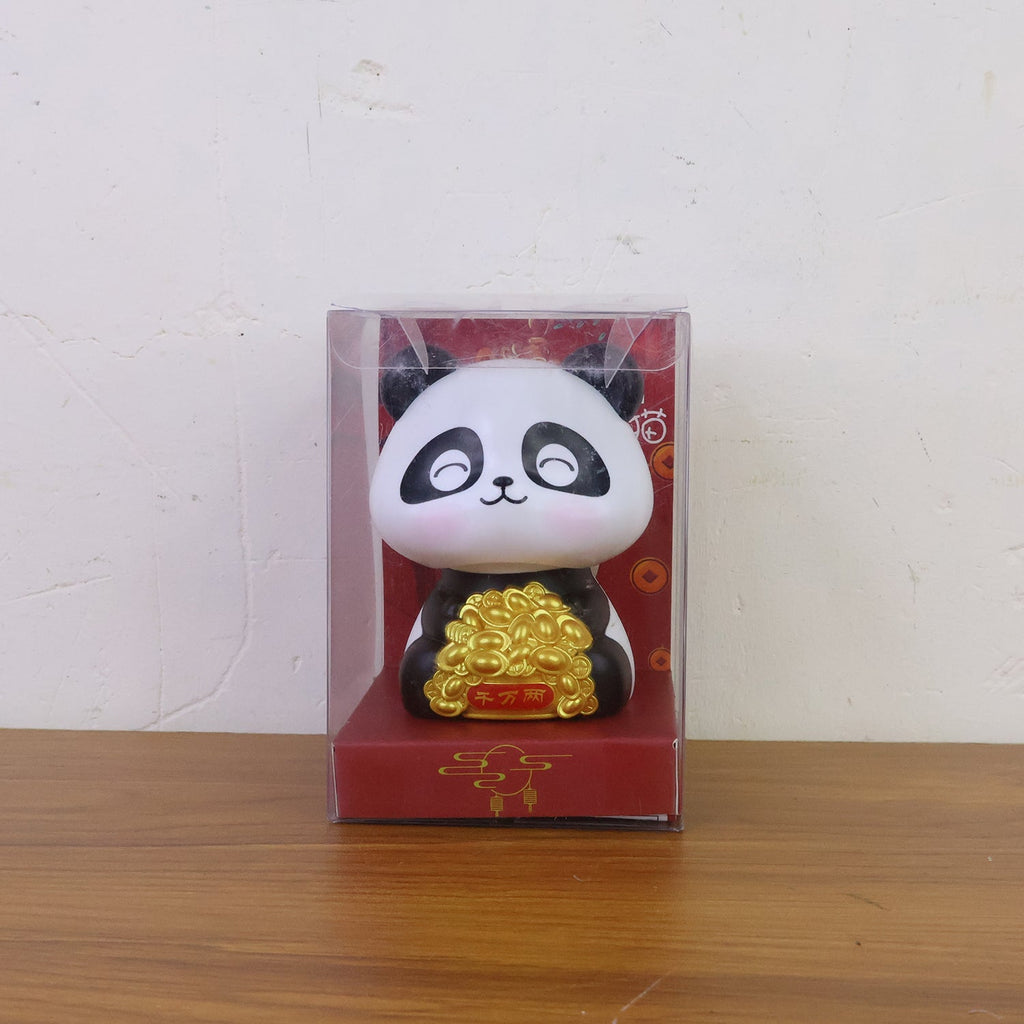 Multiple solar panda figurines in various poses, emphasizing their charm as car interior accessories.