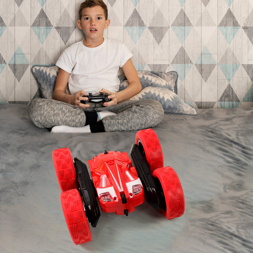 Remote control stunt car in action with 360 degree flips on terrain