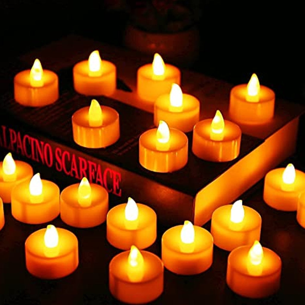 A single white LED tealight candle flickering gently, showcasing its realistic effect.