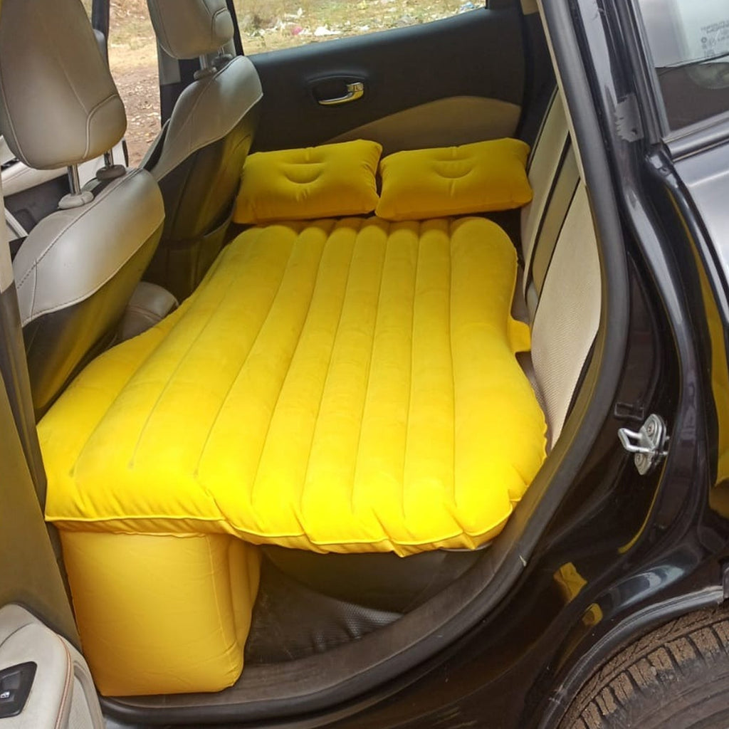Inflatable car bed providing a cozy sleeping space in a car for a relaxed journey.
