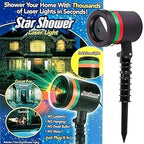 Decorative laser light patterns illuminating a garden and home exterior for celebrations.