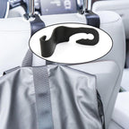 Compact car back support hanger securely attached to a car seat.