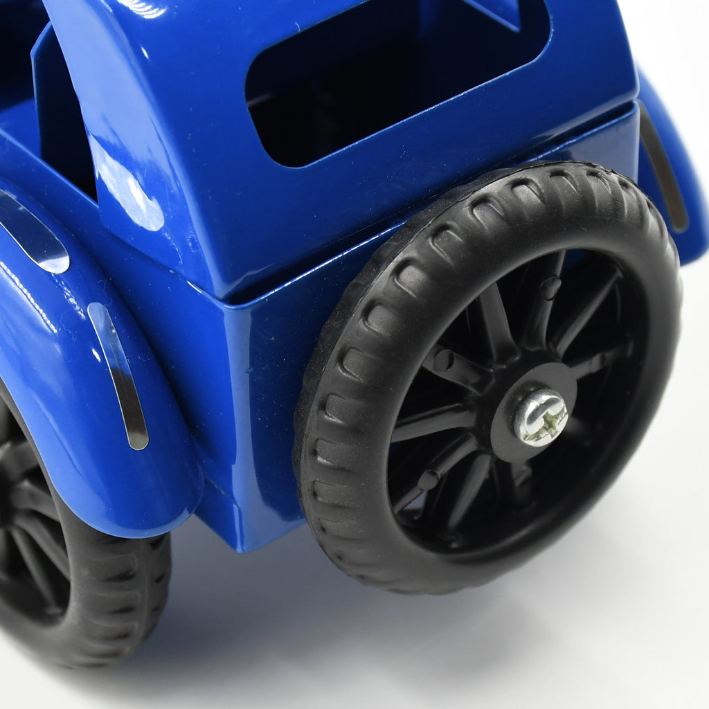 Side view of the metal car, highlighting its durable build.