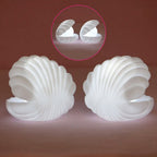 A child's hand reaching for the gentle glow of the Pearl Shell Night Lamp.